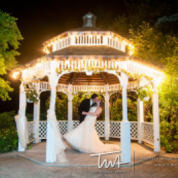 Gazebo lighted up with Bride and Groom